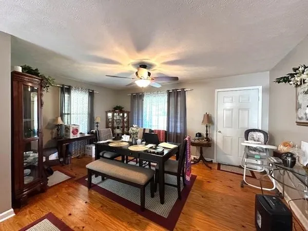 a living room with furniture a rug and a chandelier