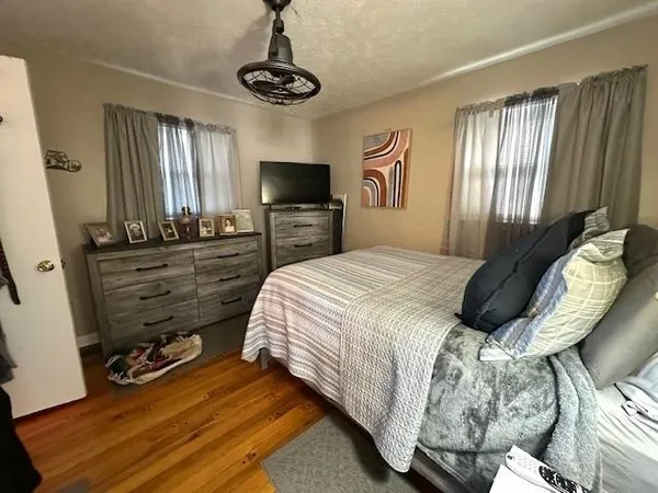 a bedroom with a bed and a television