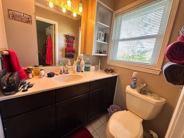 a bathroom with a sink vanity mirror and toilet