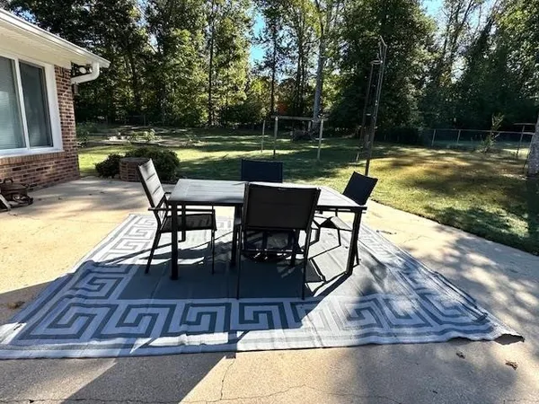 a view of swimming pool with chairs and a table