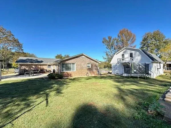 a front view of a house with a garden and deck