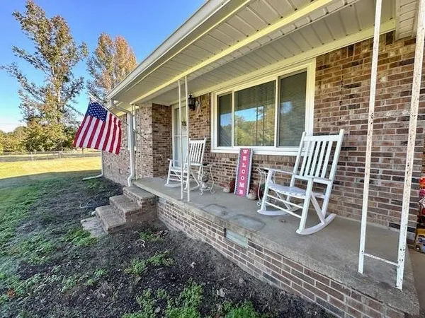 a chairs and table in the backyard of the house