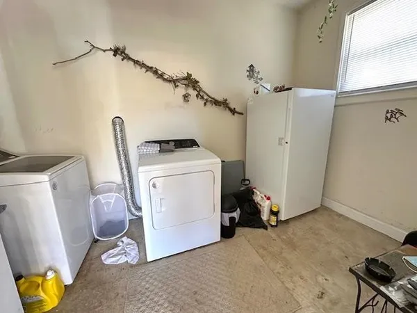 a view of storage and utility room with two washing machine