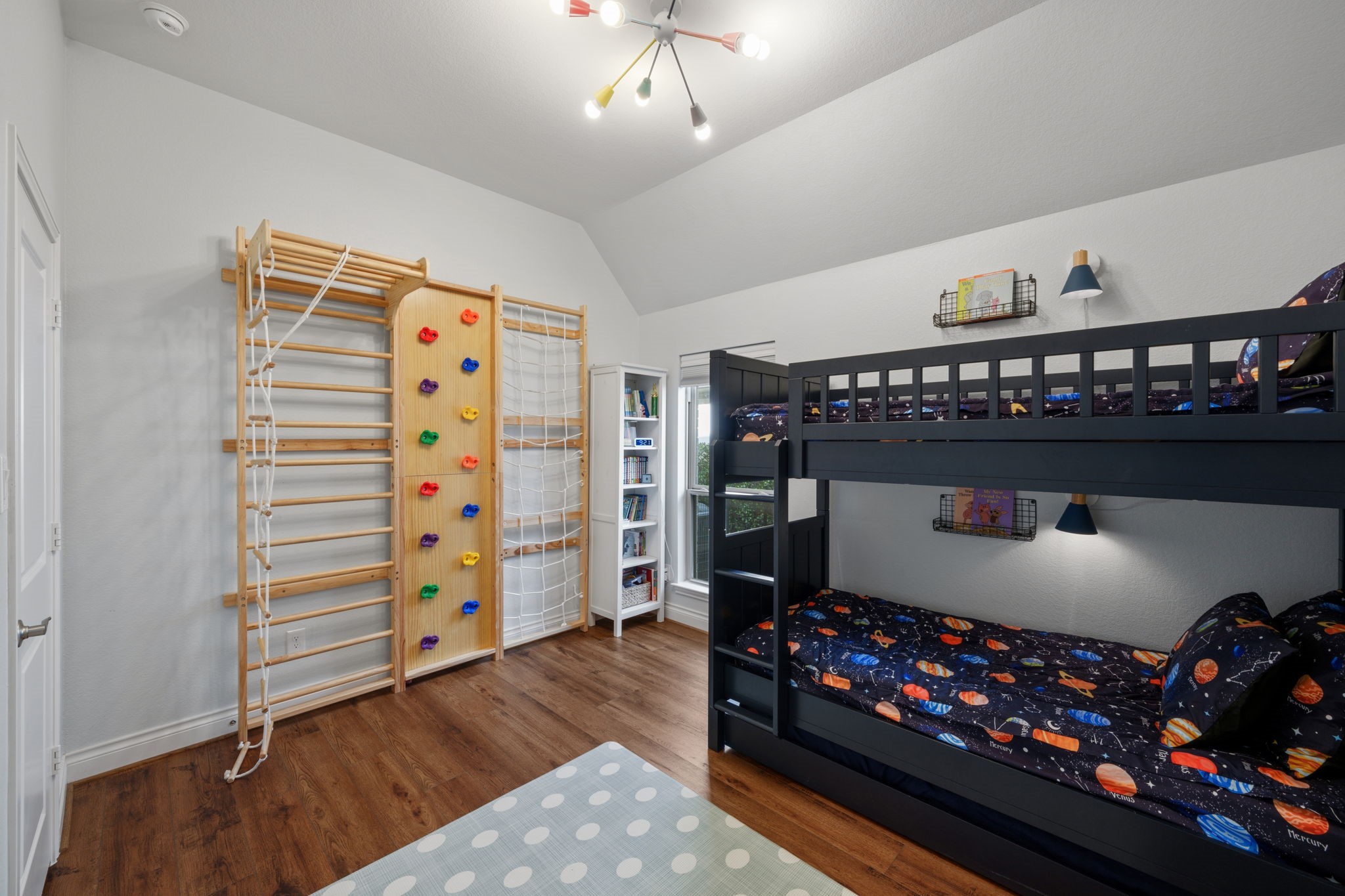 2119 Blackhawk Ridge Lane Manvel, TX 77578 - Photo 28 of 49 Fun and functional secondary bedroom with vaulted ceiling — currently featuring a built-in climbing wall and bunk beds.
