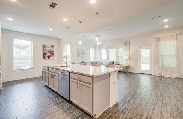 a large kitchen with stainless steel appliances granite countertop a lot of counter space