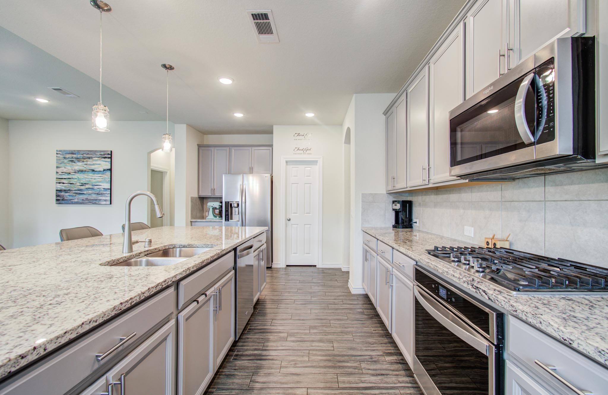 27817 Ellie Oak Lane Spring, TX 77386 - Photo 18 of 49 a large kitchen with stainless steel appliances granite countertop a stove and a sink