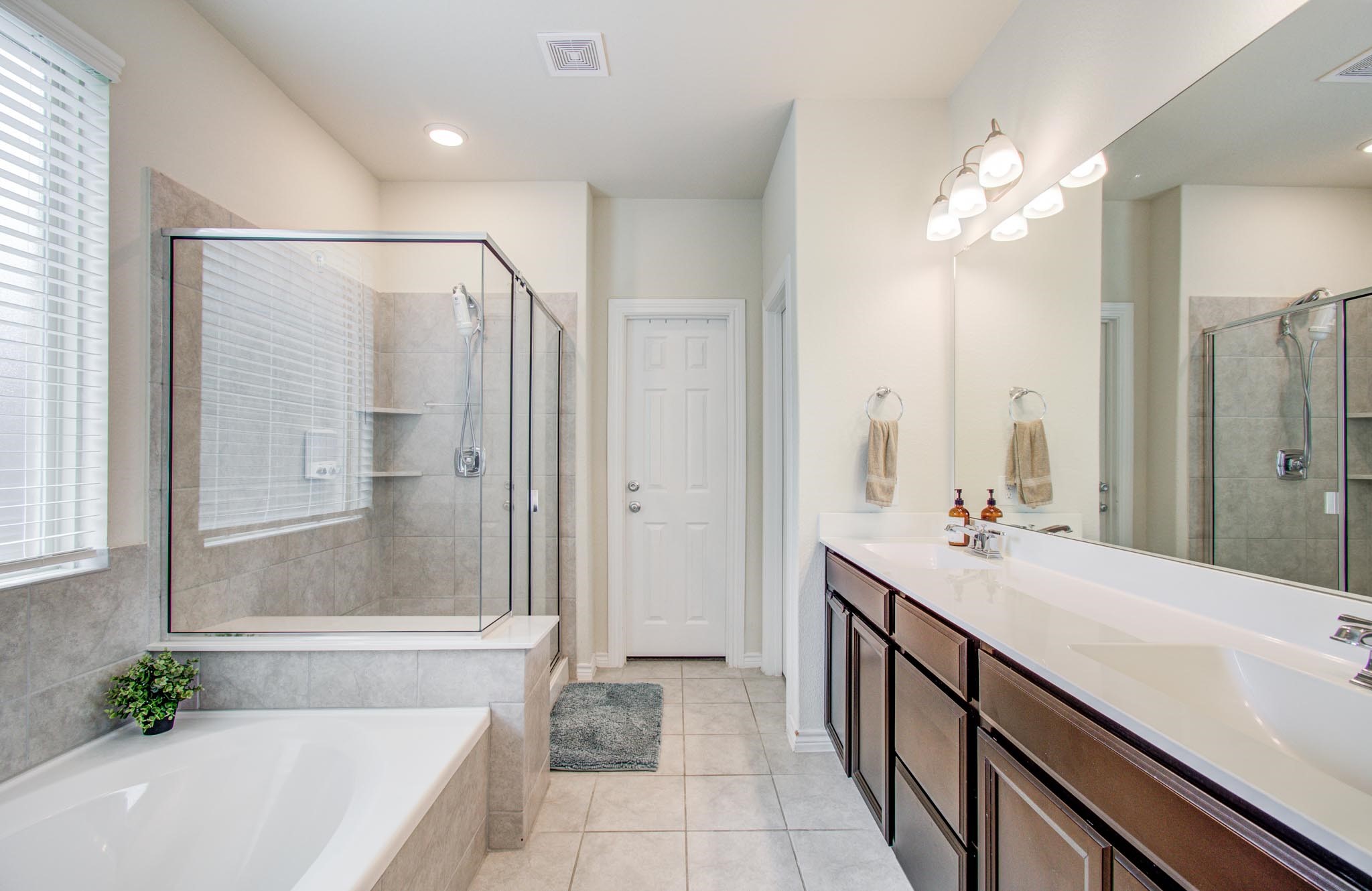 27817 Ellie Oak Lane Spring, TX 77386 - Photo 25 of 49 a spacious bathroom with a bathtub shower sink and mirror