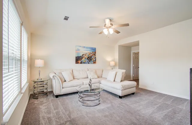 a living room with furniture and windows