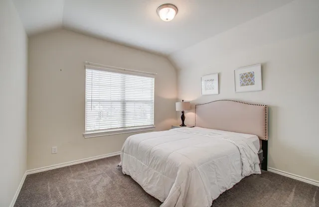 a bedroom with a bed and a chair