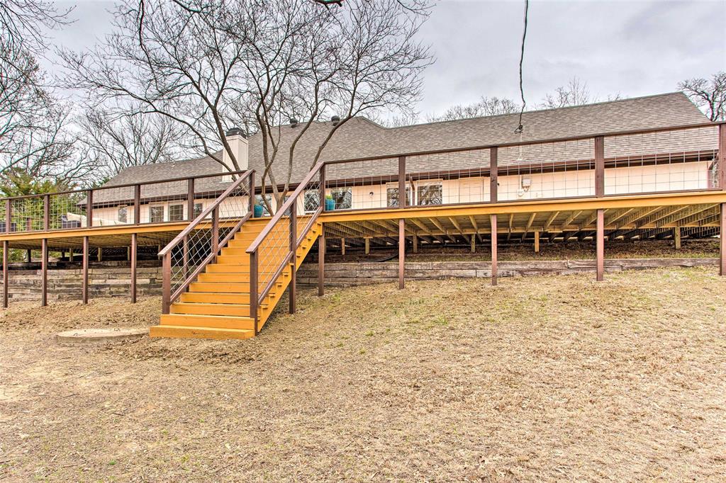 997 Tanglewood Trail Pottsboro, TX 75076 - Photo 8 of 35 Rear view of property with a shingled roof, a chimney, a wooden deck, and stairs