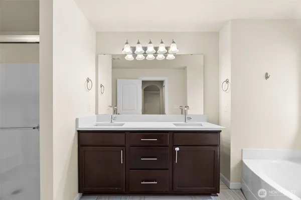 a bathroom with a sink double vanity and a mirror