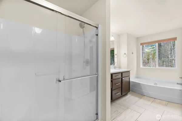 a bathroom with a bathtub and a shower