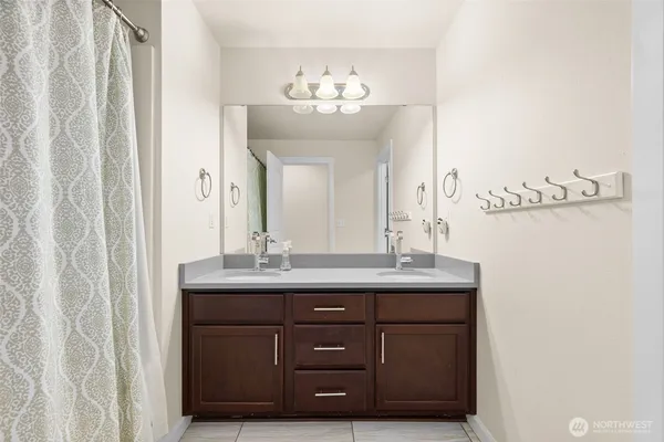 a bathroom with a granite countertop sink a mirror and a vanity