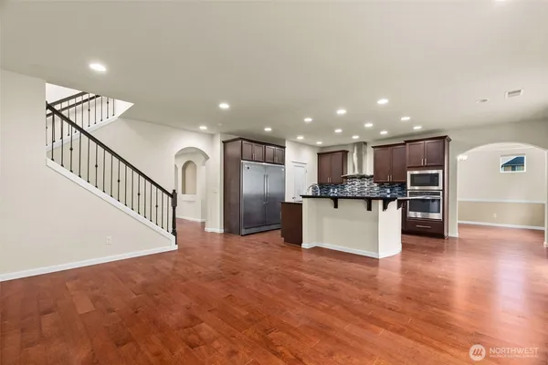 a view of kitchen with kitchen island sink stainless steel appliances and cabinets
