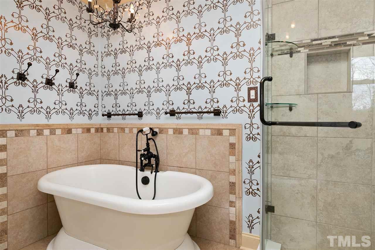 3105 Julian Drive Raleigh, NC 27604 - Photo 14 of 30 a white bath tub sitting in a bathroom
