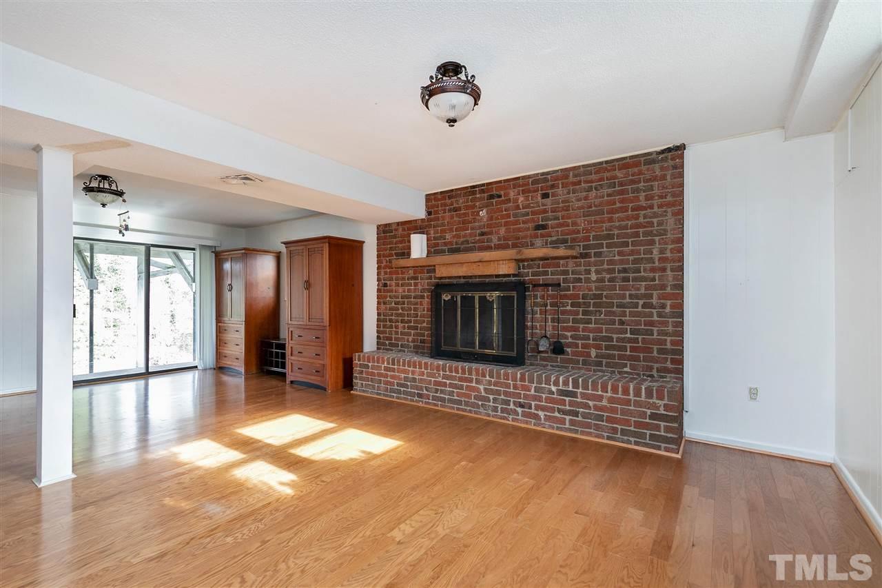 3105 Julian Drive Raleigh, NC 27604 - Photo 18 of 30 a view of empty room with a fireplace and wooden floor