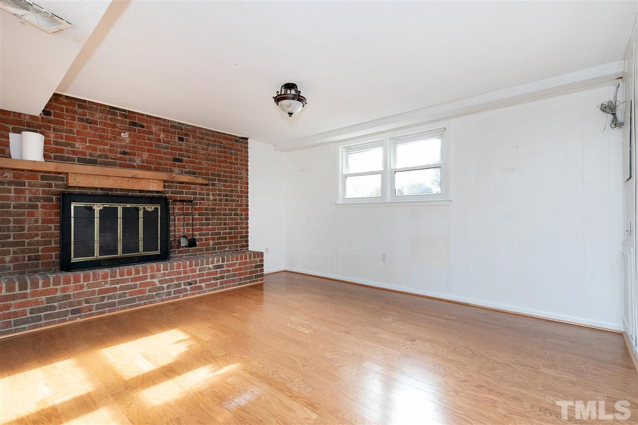 3105 Julian Drive Raleigh, NC 27604 - Photo 23 of 30 a view of an empty room with a fireplace and a window