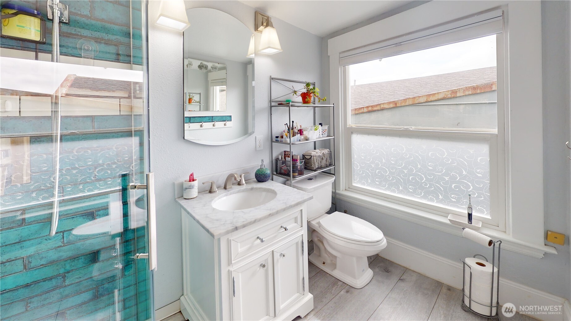 505 K Street Hoquiam, WA 98550 - Photo 19 of 39 a bathroom with a sink a toilet a mirror and shower