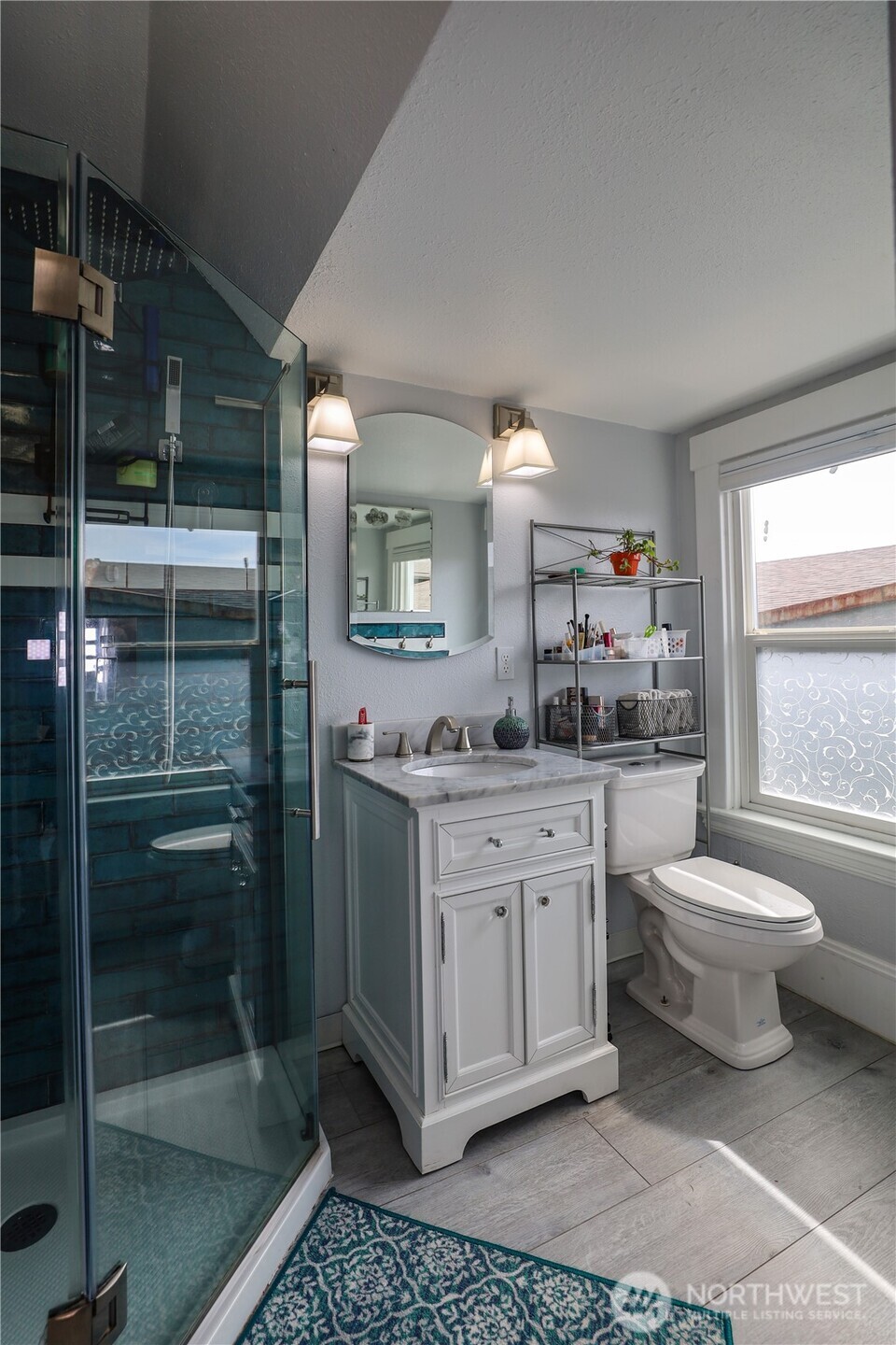 505 K Street Hoquiam, WA 98550 - Photo 20 of 39 a bathroom with a granite countertop sink mirror vanity and toilet