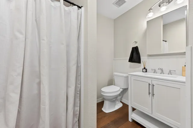 a bathroom with a sink toilet and vanity