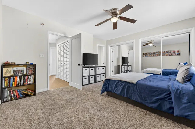 a bed room with a bed and a book shelf