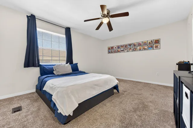 a bedroom with a bed and a window