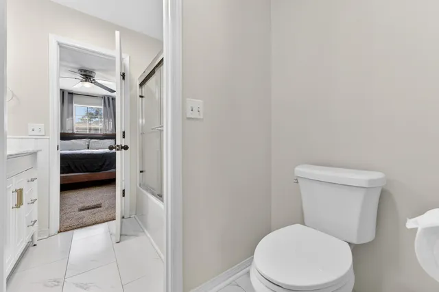 a white toilet sitting next to a bathroom sink