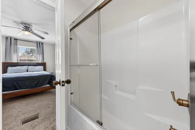 a bathroom with a tub and shower
