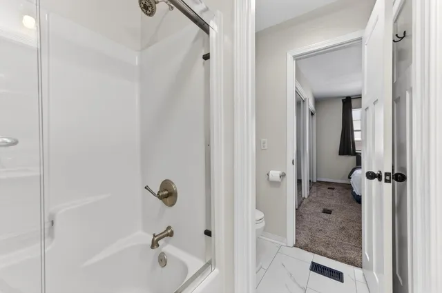 a bathroom with a granite countertop bathtub shower and a sink