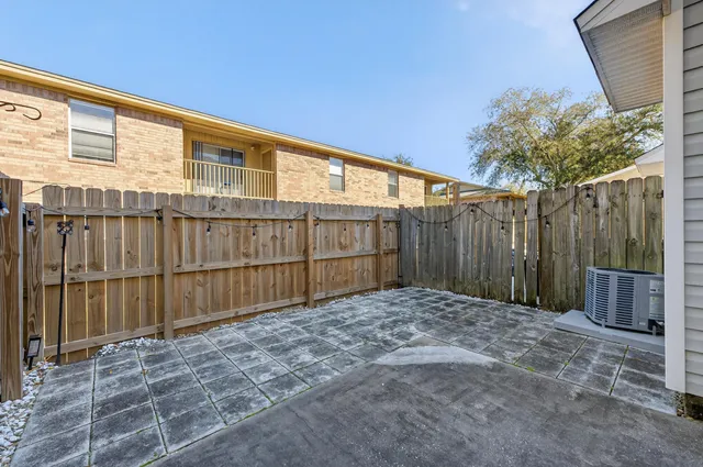 a view of backyard with wooden fence