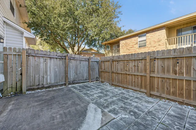 a view of backyard with wooden fence