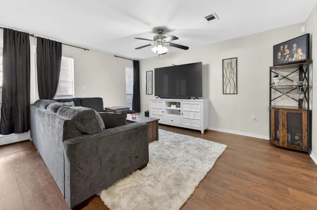 a living room with furniture and a flat screen tv