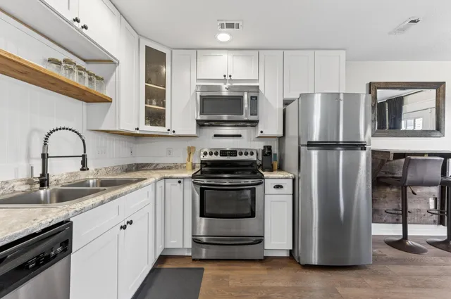 a kitchen with a refrigerator stove and sink