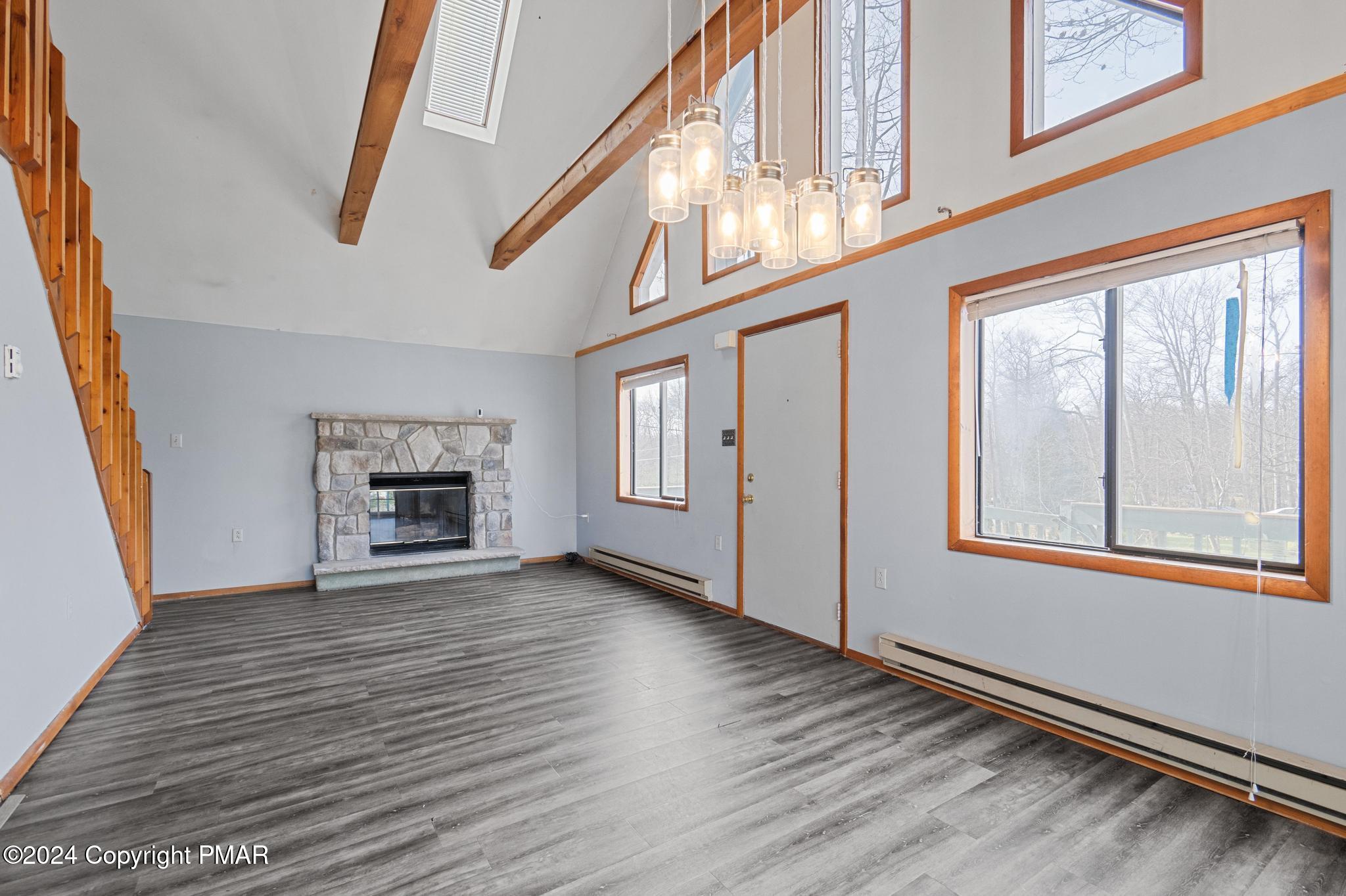 203 Coach Road Tobyhanna, PA 18466 - Photo 21 of 45 a view of an empty room with wooden floor and a window