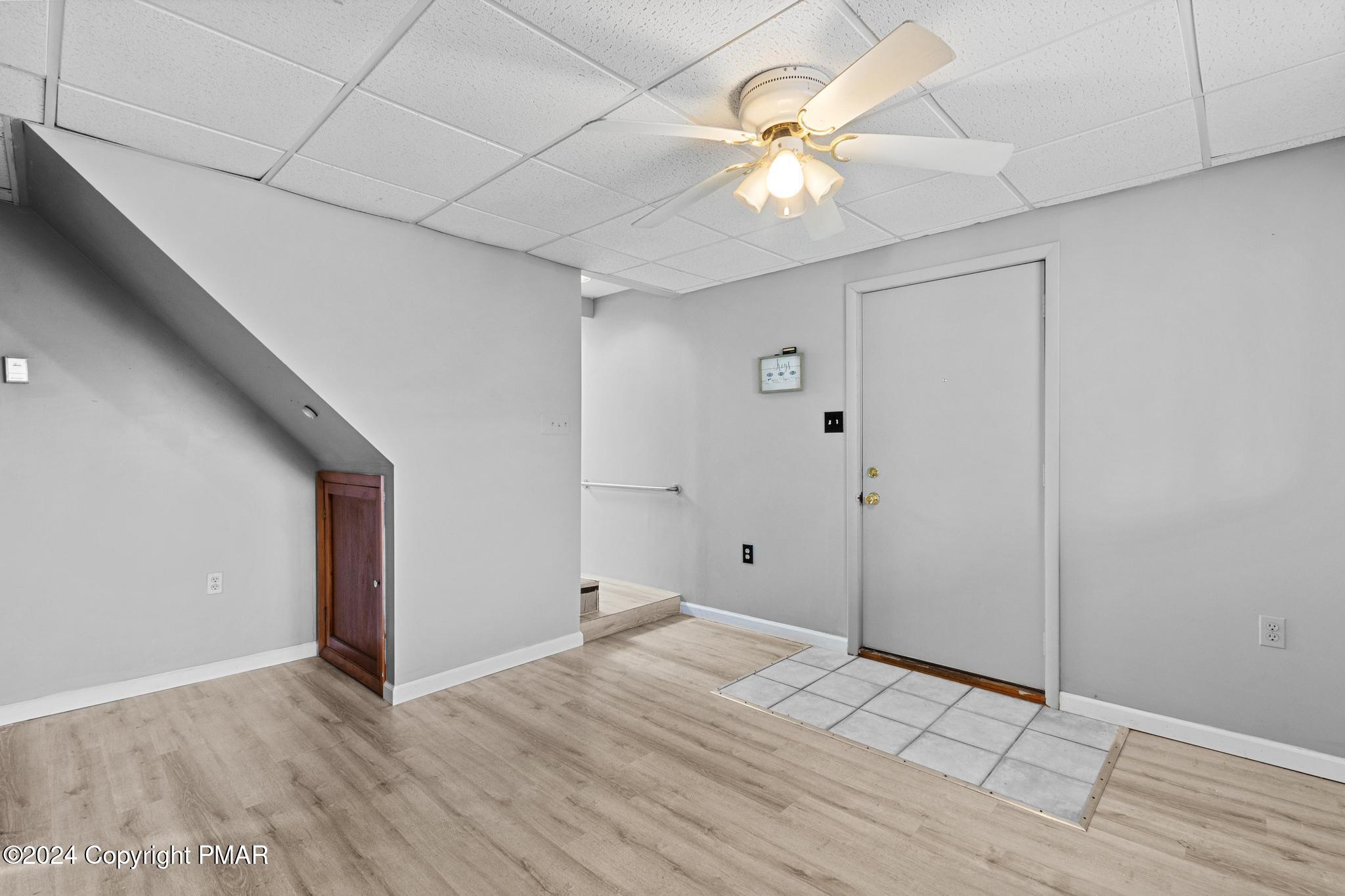 203 Coach Road Tobyhanna, PA 18466 - Photo 36 of 45 wooden floor in an empty room with a chandelier fan