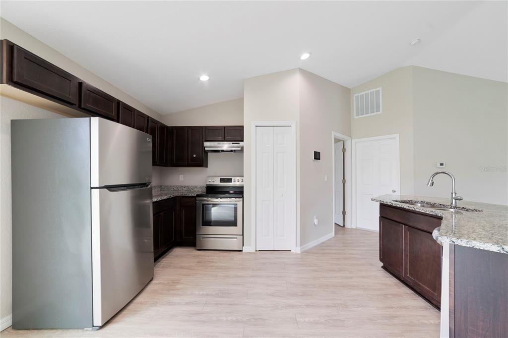 16271 Southwest 27th Terrace Road Ocala, FL 34473 - Photo 6 of 21 a kitchen with stainless steel appliances granite countertop a refrigerator and a stove top oven