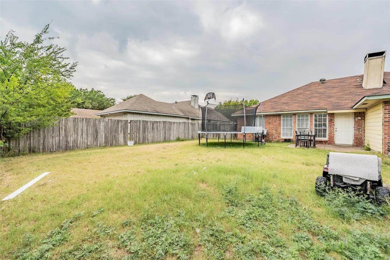 4520 Wedgecrest Drive Dallas, TX 75232 - Photo 18 of 19 a view of a house with a swimming pool and a yard
