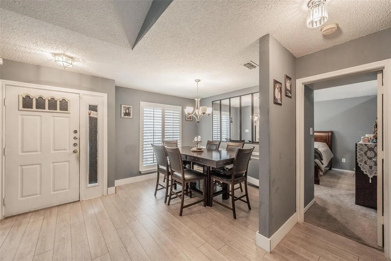 4520 Wedgecrest Drive Dallas, TX 75232 - Photo 3 of 19 a view of a dining room with furniture and a chandelier