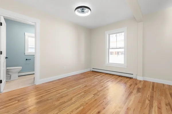 wooden floor in an empty room with a window