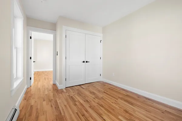 a view of a room with wooden floor