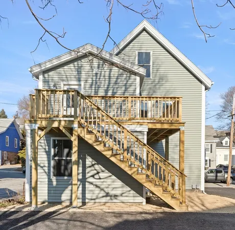 a view of a house with wooden fence