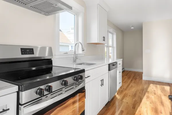 a kitchen with stainless steel appliances granite countertop a stove and a sink