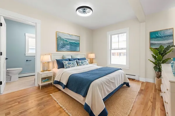 a bedroom with a large bed and a window
