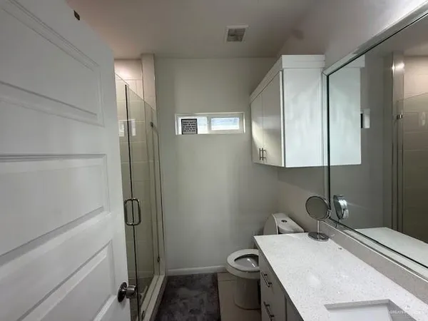 a bathroom with a sink toilet and a mirror