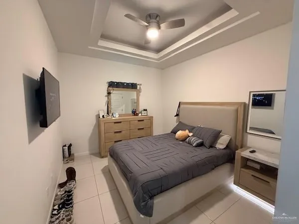 a bedroom with a bed and a flat screen tv