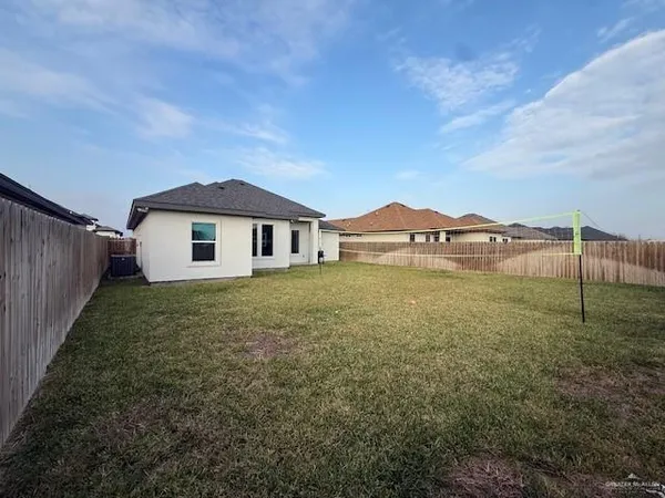 a view of a house with a yard and a garage