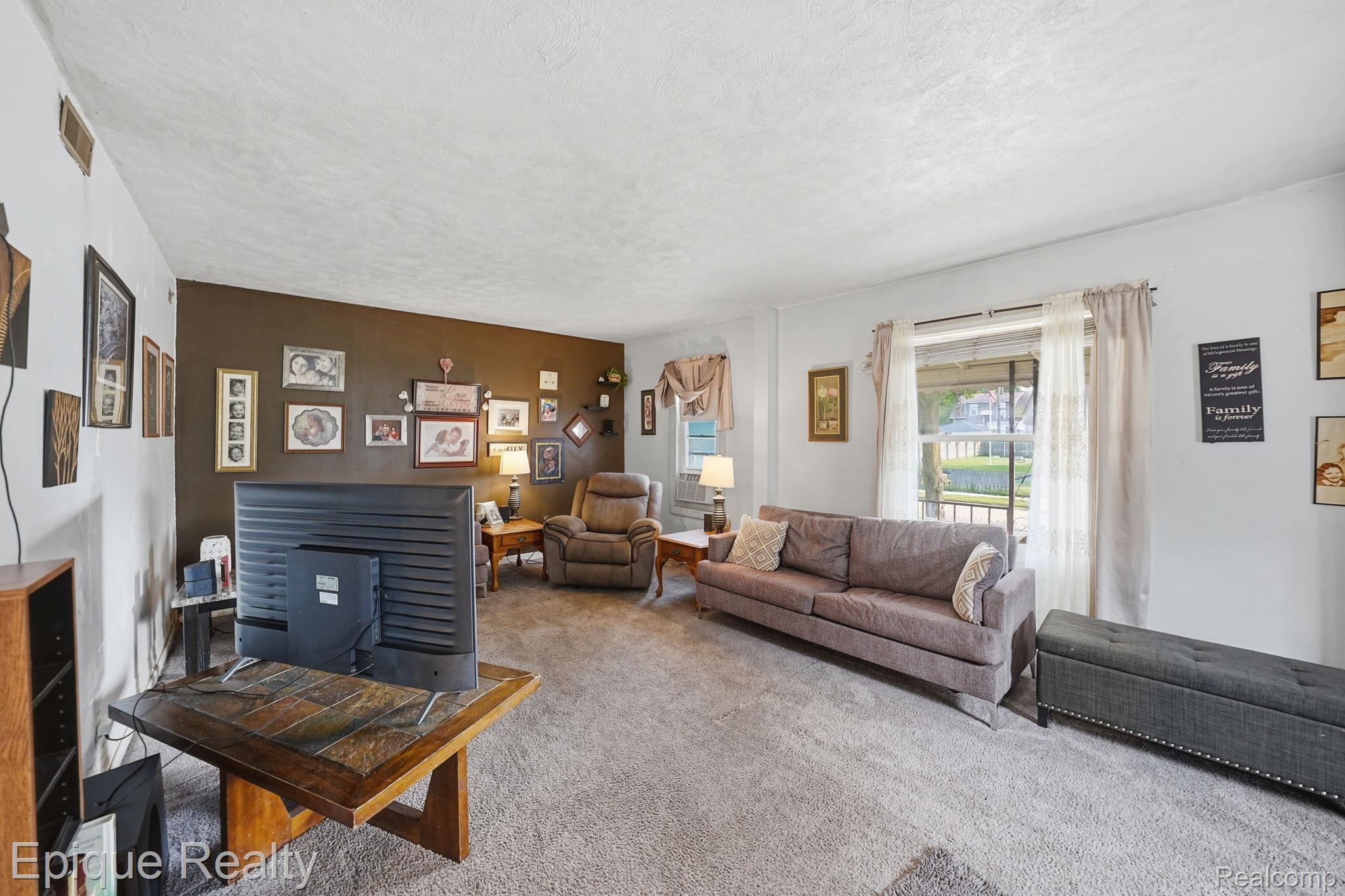 75 East Cicotte Street River Rouge, MI 48218 - Photo 6 of 25 Spacious living area featuring neutral carpeting, white ceiling, and a prominent window