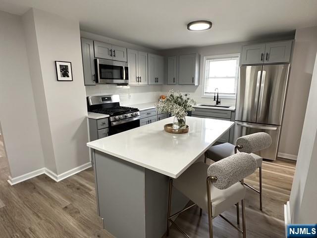 195 Valley Road, Unit 1 Clifton, NJ 07013 - Photo 2 of 8 a kitchen with a table chairs microwave and refrigerator