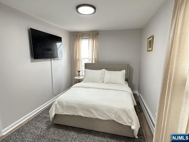 195 Valley Road, Unit 1 Clifton, NJ 07013 - Photo 3 of 8 a bedroom with a bed and a flat screen tv