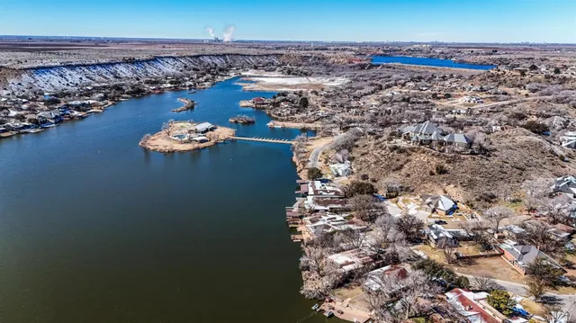 a view of a dry yard with wooden fence